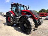 a red tractor that is parked in a parking lot