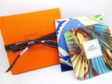 an orange box with a tie and a picture of a woman in a colorful dress