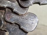 a close up of a metal object with a name on it