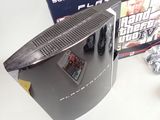 a video game system sitting on a table next to a box of games