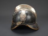 an old helmet with a lion head on it on a gray background