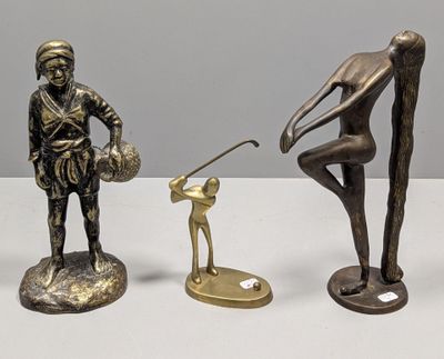 three bronze figurines of a man with a golf club and a dog