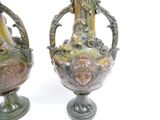two vases sitting side by side on a white surface