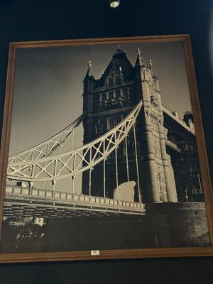 a picture of a picture of a bridge hanging on the wall
