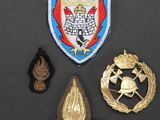 three badges and a badge on a black surface