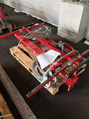 a red fire hydrant sitting on top of a wooden pallet