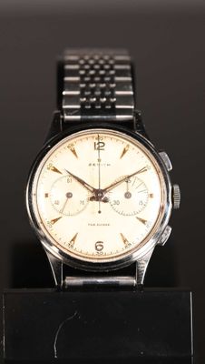 an image of a close up of a watch on a black surface