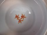 a white bowl with a red starfish design on it