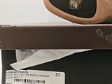 the shoe box has a pair of shoes on top of it