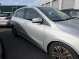 a silver car parked in a parking lot with other cars