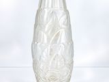 a glass vase sitting on a table with a white background