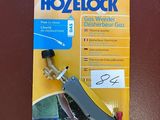 a close up of a package of hoselock with a person holding a hose