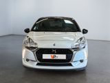 the front of a white car in a white room