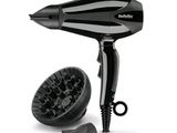 a black blow dryer and a hair brush on a white background