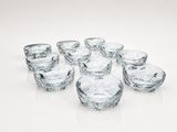 a group of glass bowls sitting on a white surface