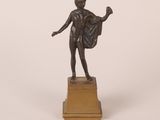 an image of a bronze statue of a woman with a cape