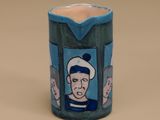 a blue vase with a picture of a man and a woman on it