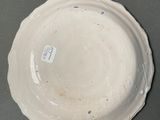 a white plate with a tag on it on a table