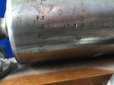 a metal pipe that is sitting on top of a wooden table