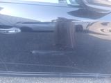 an image of a car with a towel hanging out of it ' s hood