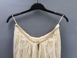 a close up of a dress hanging on a hanger on a wall