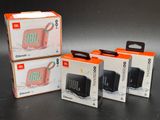 three boxes of jbl go portable speaker sitting next to each other