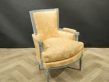 an image of a chair with a yellow upholstered cushion