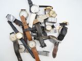 many different types of watches on a white surface