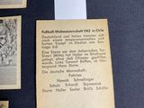 several old football cards are on display on a table