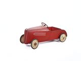 a red toy car sitting on a white surface