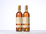 two bottles of wine sitting on top of a table next to each other