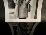 a black and white photo of a woman in a trench coat