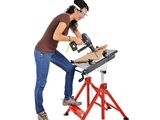 an image of a woman using a power saw to cut a piece of wood