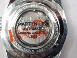 a close up of a watch on a white surface