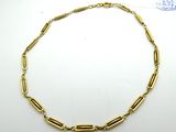 a gold necklace with a link and a clasp