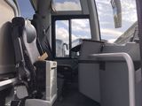 a view of the inside of a bus from the passenger seat