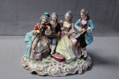 a figurine of a group of people sitting on a table