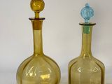 three glass bottles sitting next to each other on a table
