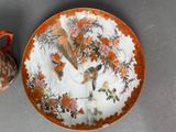 a plate with a bird and flowers on it