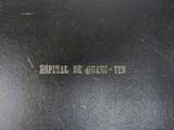 the back of a black leather bag with writing on it
