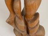 wooden sculpture of a couple holding hands on a white background