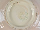 a white bowl with a green design on it