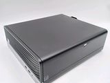 an image of a black computer sitting on top of a white surface