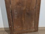 an old wooden door that is leaning against the wall