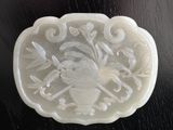 a picture of a white jade plaque with a bird on it