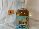a bottle of rum sitting on a white sheet