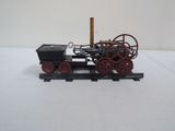 a small model of a steam engine on a train track
