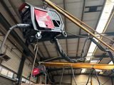 a picture of a man working on a machine in a building