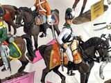 five figurines of men riding horses on display