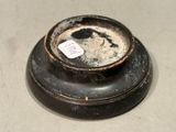 a black bowl with a tag on it sitting on a table